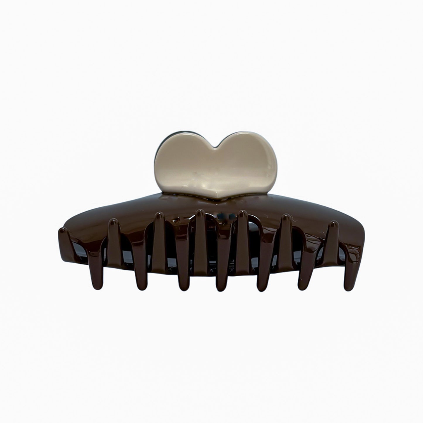 The One Love Clip features a glossy two-tone chocolate and cream design with a heart-shaped top and wide teeth for secure, stylish hold.