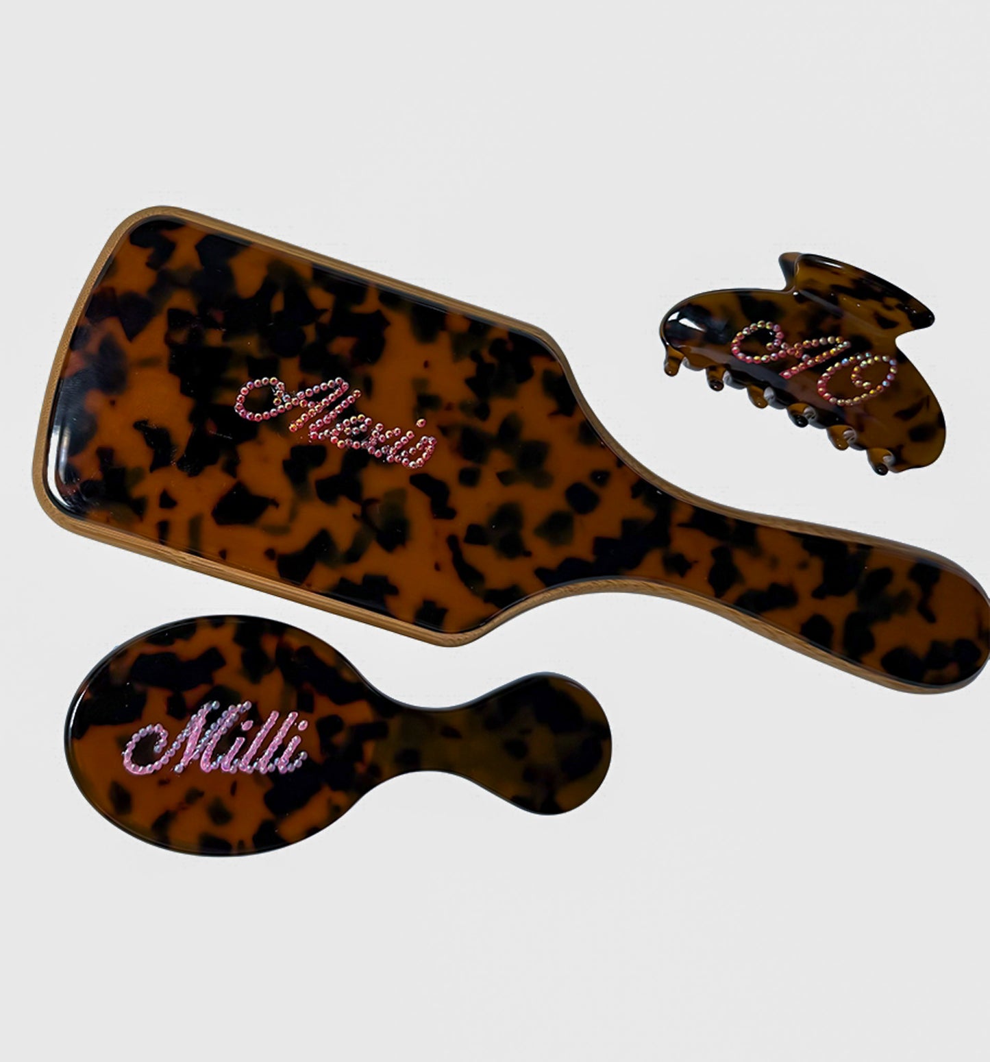 Custom tortoise hair care set — personalized paddle brush, mini brush, and claw clip with rhinestone names by Local Love by Lauren.
