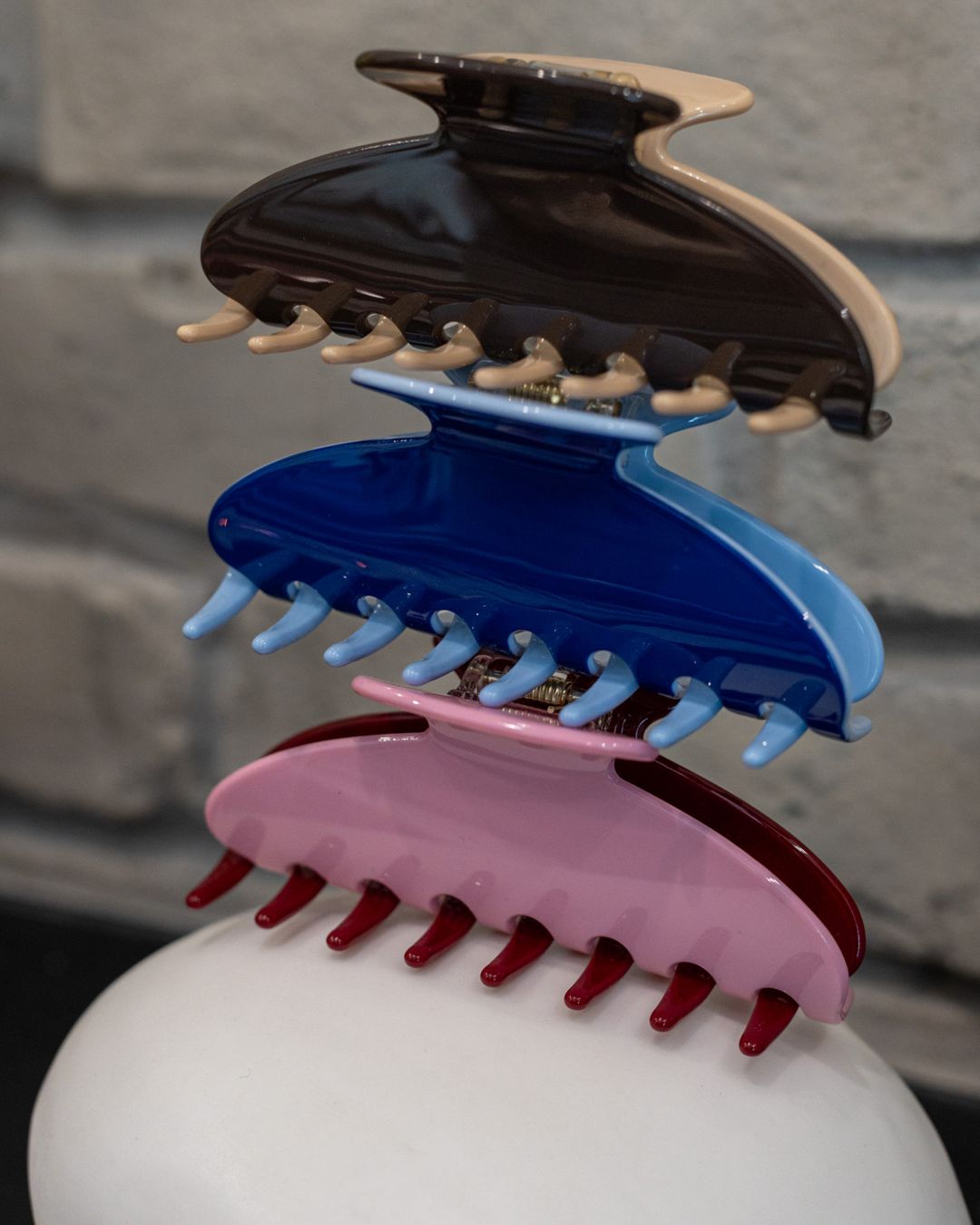 Stack of Local Love claw clips in brown, blue and pink