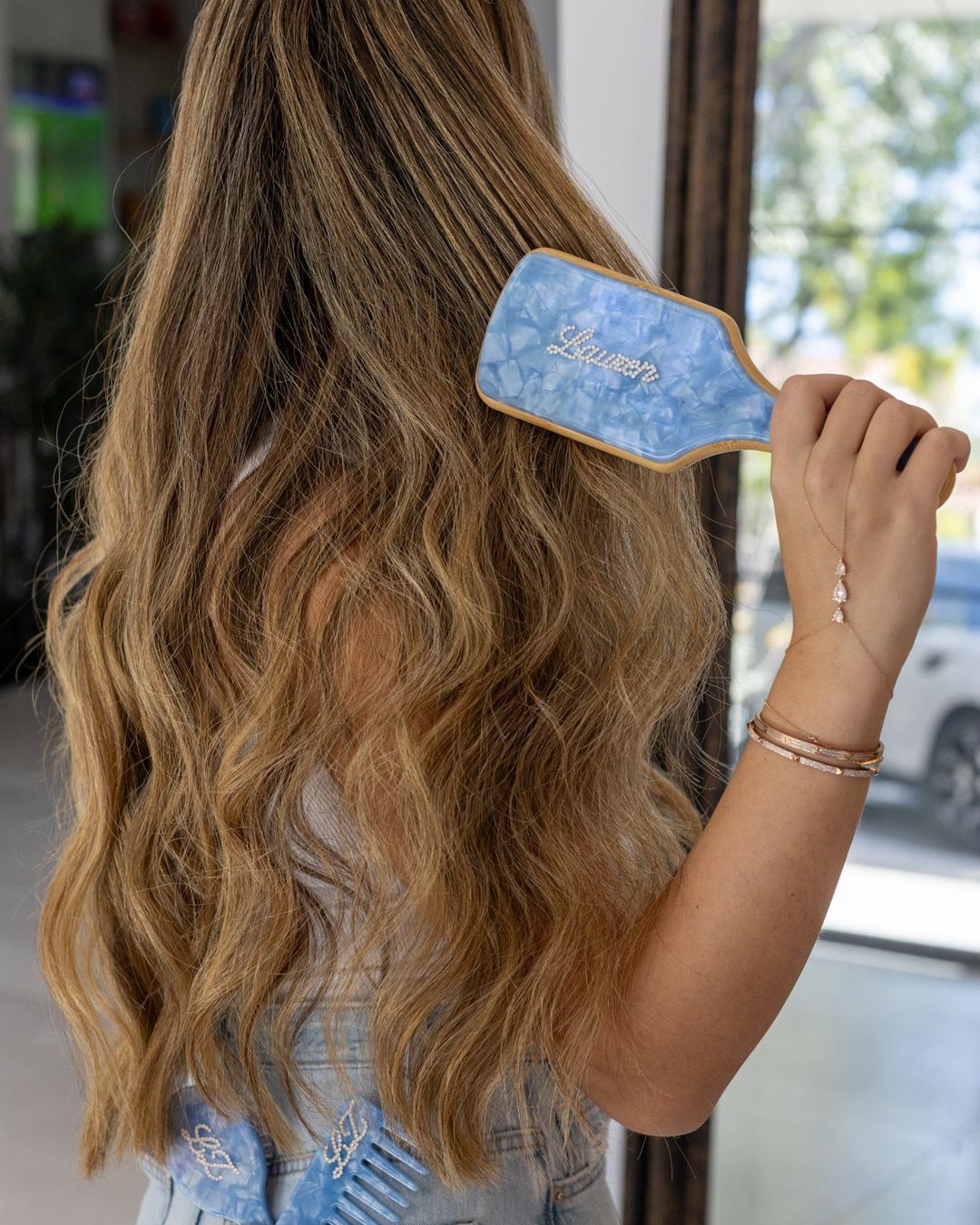 Brushing hair with a personalized blue marble brush – Local Love by Lauren