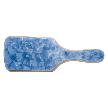 Paddle hairbrush with a glossy blue marbled back and a natural wood border, designed for a bold, stylish touch to your haircare routine.