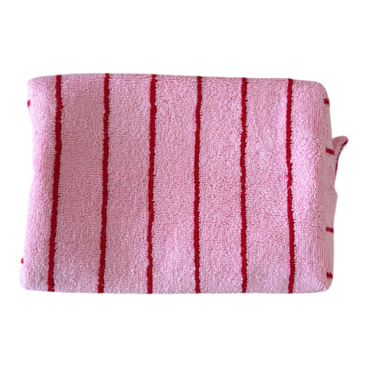 Pink towel with red stripes on a white background