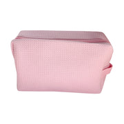 Light pink waffle-textured travel pouch with zipper and handle — cute and functional bag by Local Love by Lauren.
