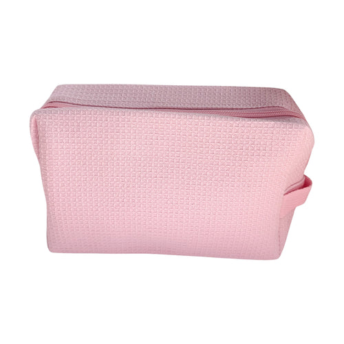 Light pink waffle-textured travel pouch with zipper and handle — cute and functional bag by Local Love by Lauren.