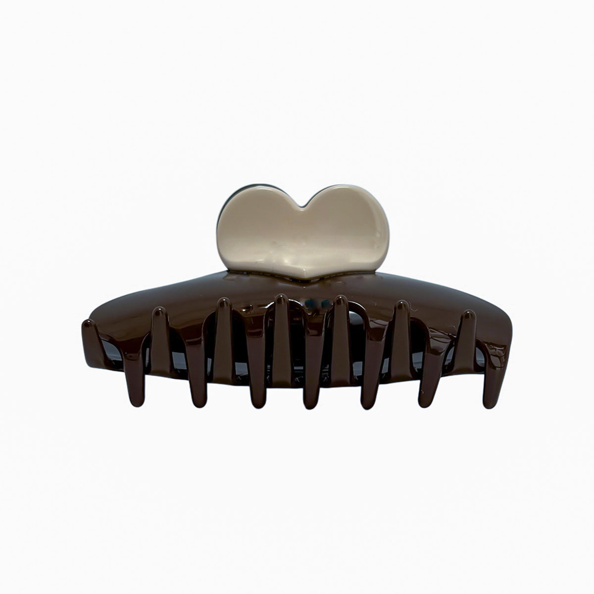 The One Love Clip features a glossy two-tone chocolate and cream design with a heart-shaped top and wide teeth for secure, stylish hold.

